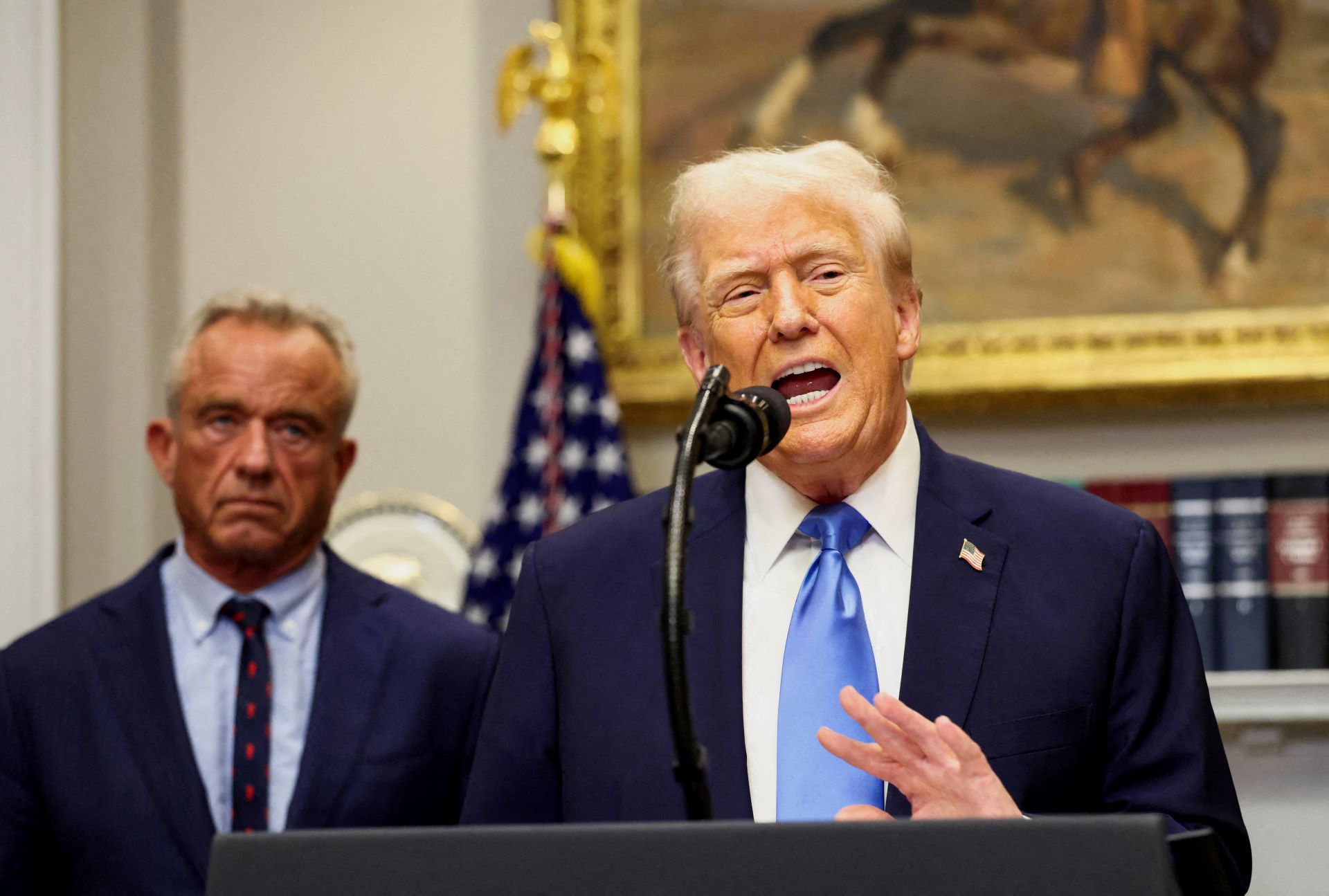U.S. President Donald Trump, next to U.S. Secretary of Health and Human Services Robert F. Kennedy Jr., makes an announcement linking autism to childhood vaccines and to the use of popular pain medication Tylenol for pregnant women and children, claims which are not backed by decades of science, at the White House, in Washington